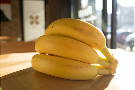 Bunch of bananas lying on the wooden, a Food & Drink Photo by oksix