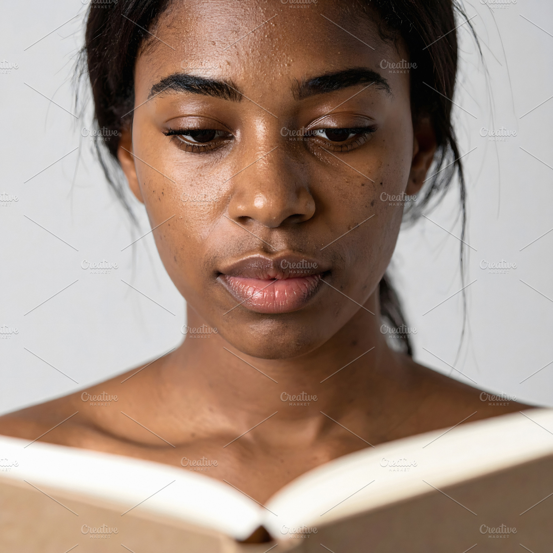 Woman reading book portrait with focused expression, a Person Photo by GoodGoods