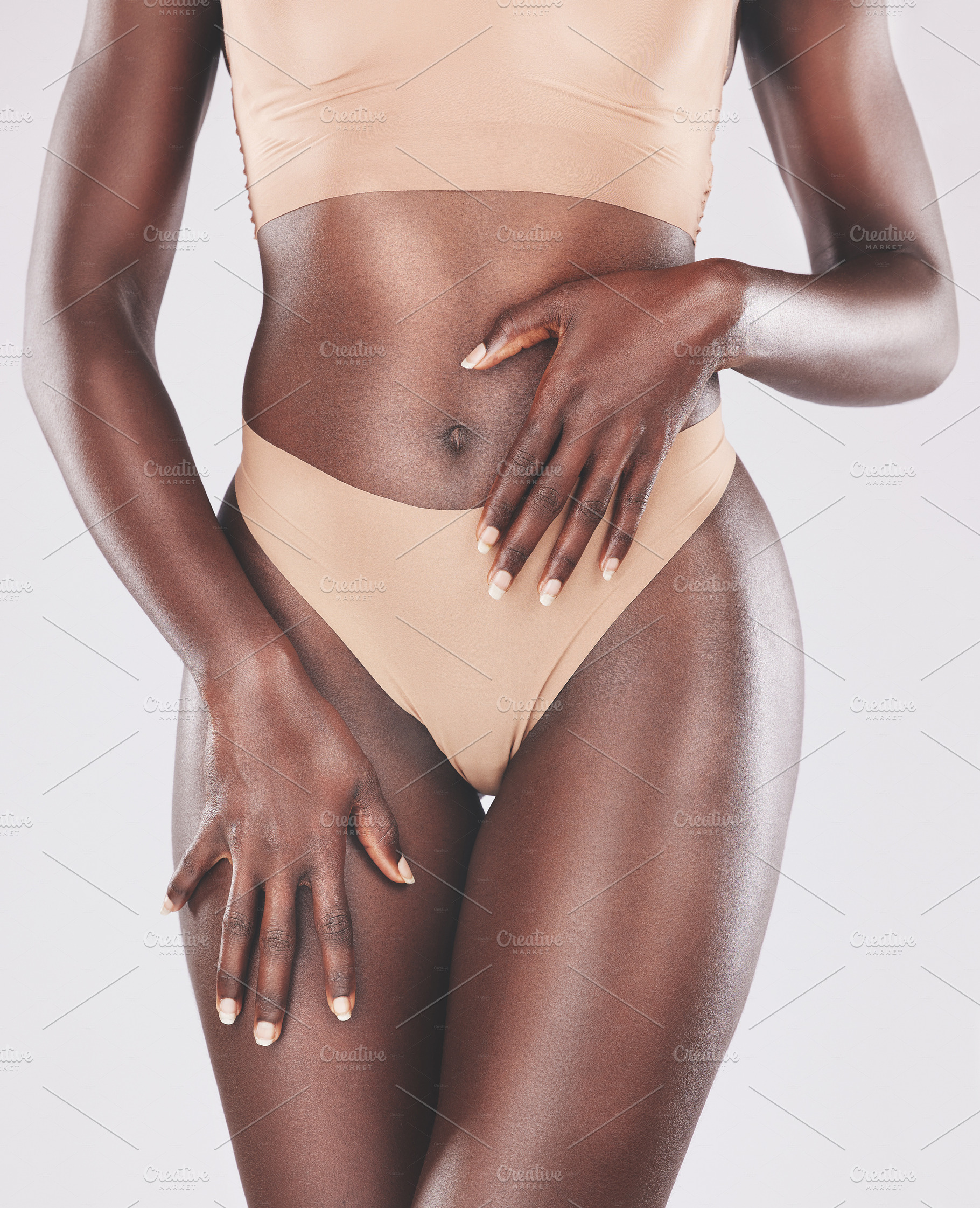 Body, hands and beauty with a model black woman in studio on a gray background wearing underwear. Health, fitness and lingerie with a female posing for diet, weightloss or a healthy lifestyle, a Photo by Peopleimages.com