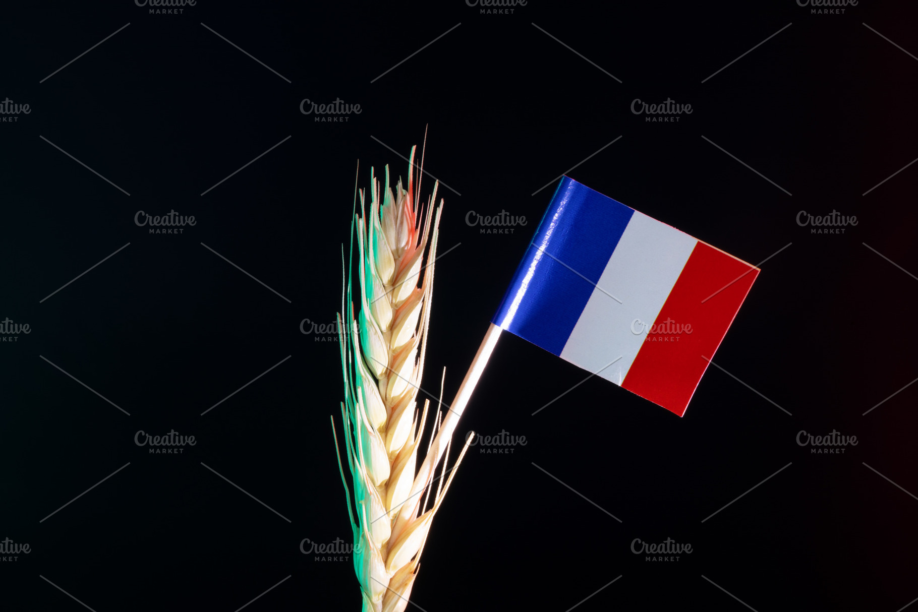 Close-up of a wheat spike paired with the French flag on a dark, an Industrial Photo by Ales Munt