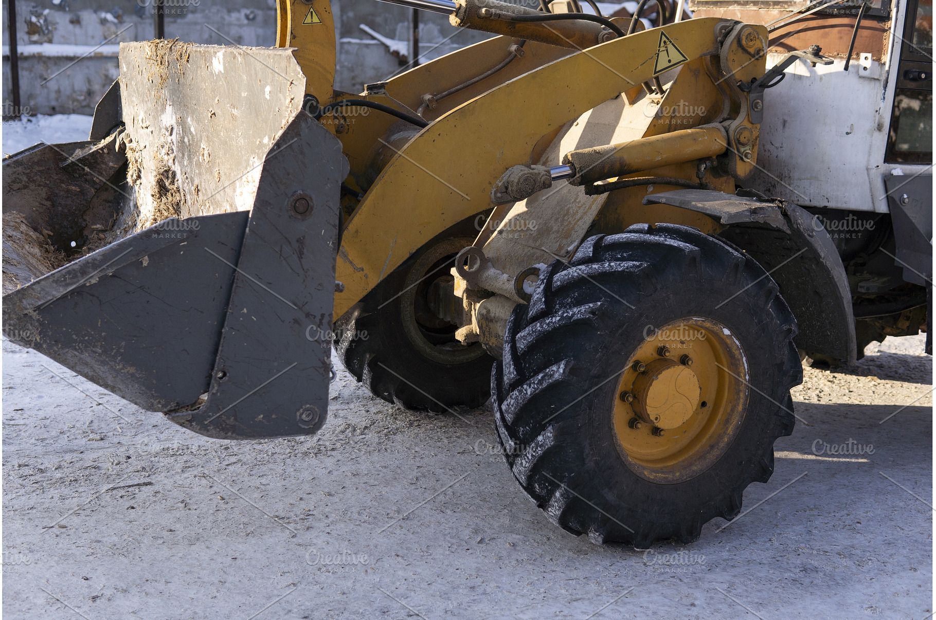 Yellow wheel loader working on, an Industrial Photo by volodymyrshtun13795