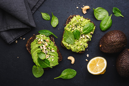 Avocado sandwich or toast on rye bread with spinach, crushed cas, a Food & Drink Photo by 5PH