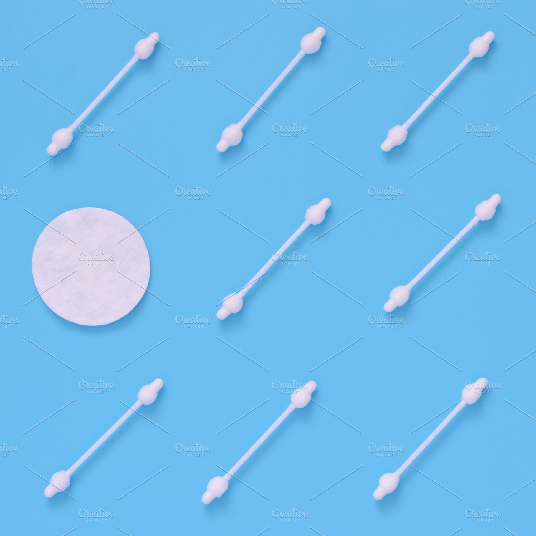 Pattern of cotton swabs and pad featuring cotton discs, pad, and swab, an Abstract Photo by Milla Mi