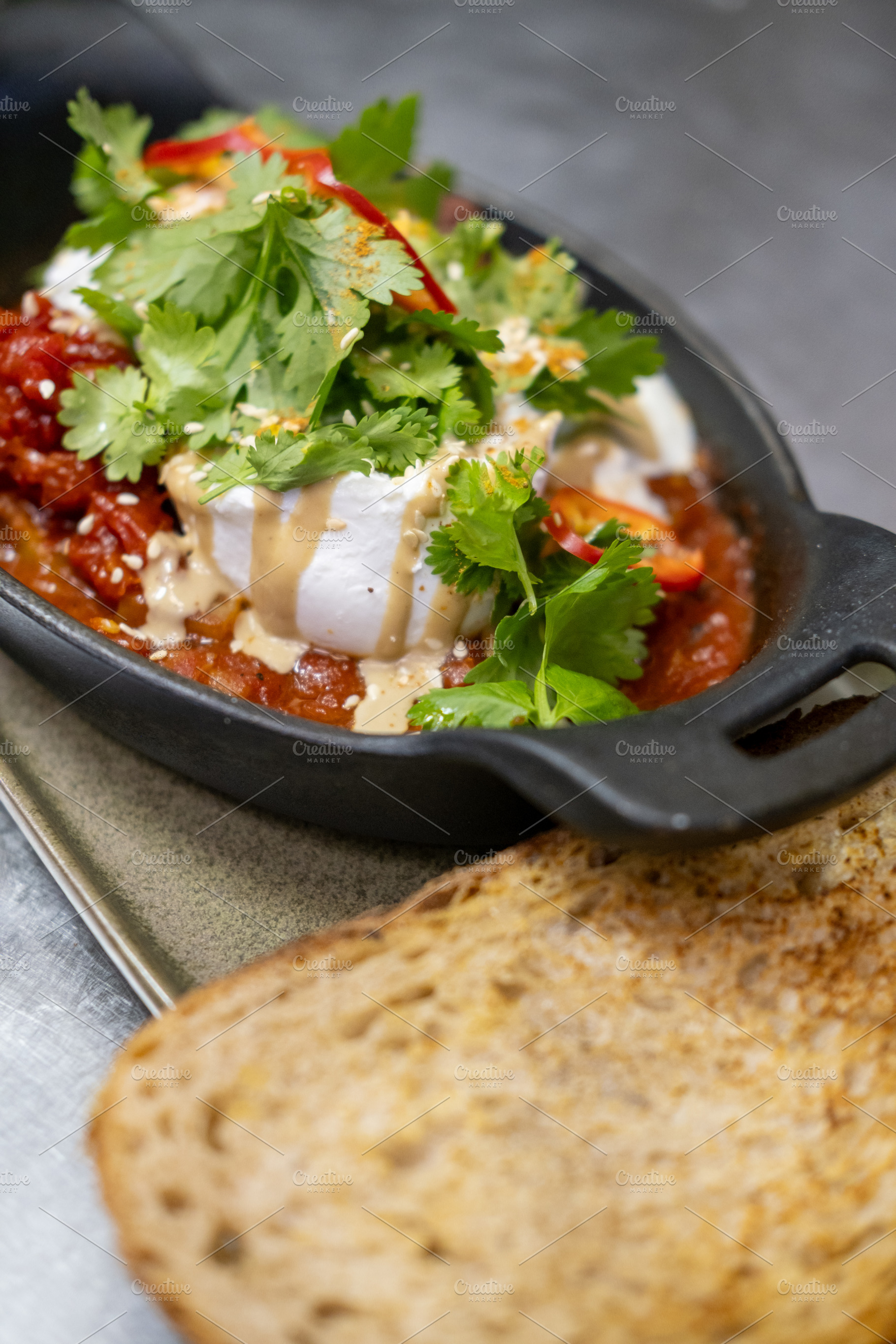 Traditional hot meal shakshuka dish food tomato, a Food & Drink Photo by Photo Drive Studio