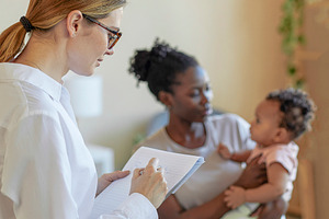 Social worker meeting with parent and infant, a Photo by DanFLCreativo