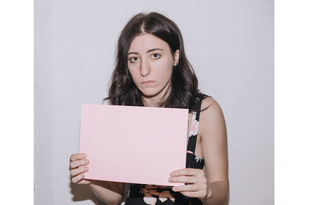 Sad young woman holding a blank, a Person Photo by zheckasmk