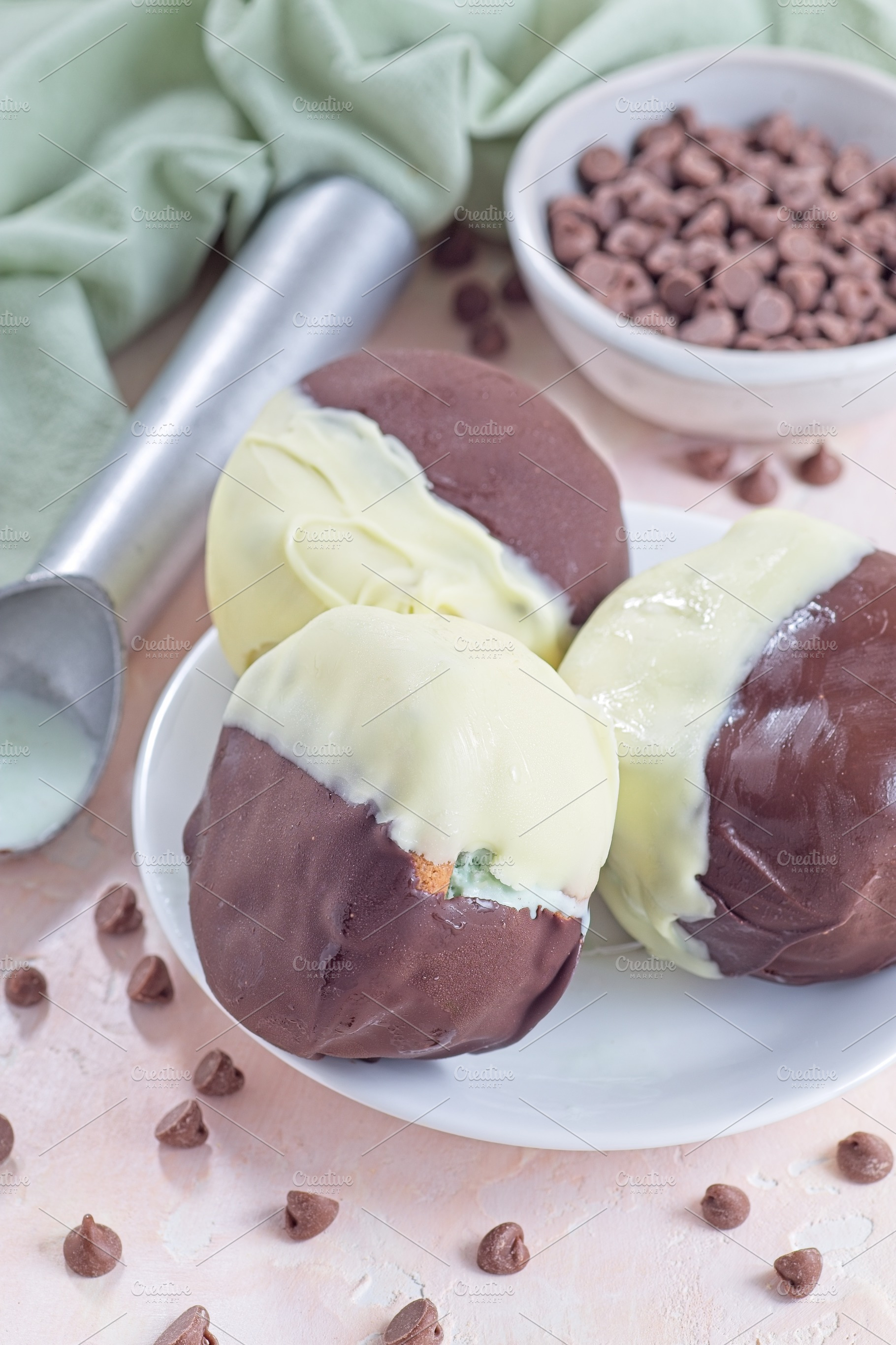 Dark and white chocolate covered ice cream sandwiches, on white plate, vertical, a Food & Drink Photo by iuliia_n