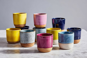 Colorful ceramic cups on neutral background, an Arts & Entertainment Photo by AlyaAnd