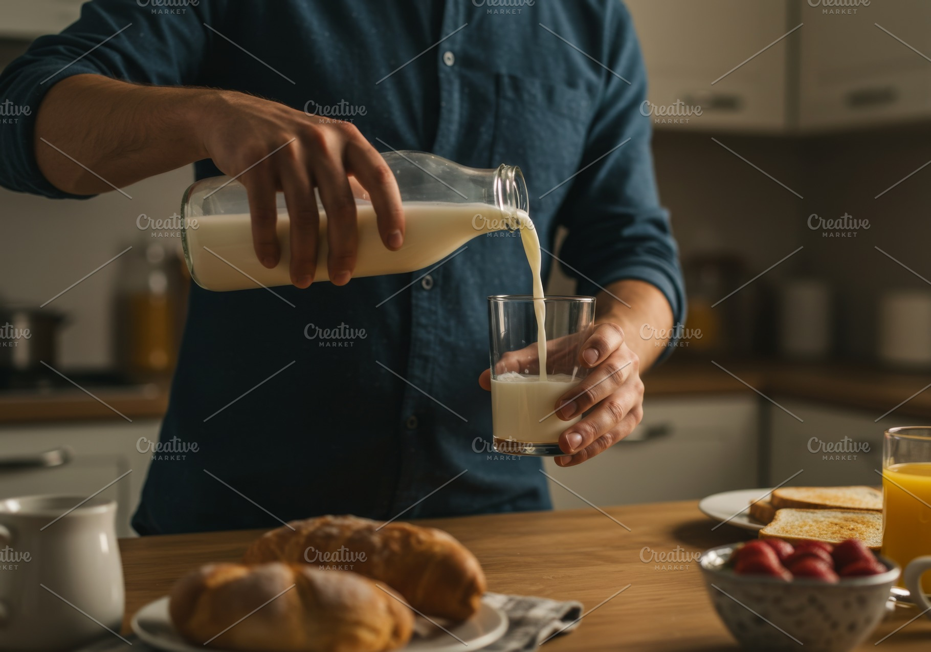 Man pouring fresh milk into a glass, a Food & Drink Photo by professorinc