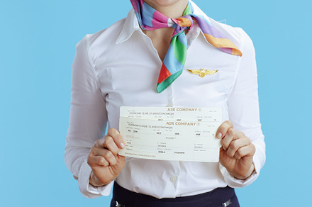 Closeup on flight attendant woman on blue, a Business Photo by Alliance Images