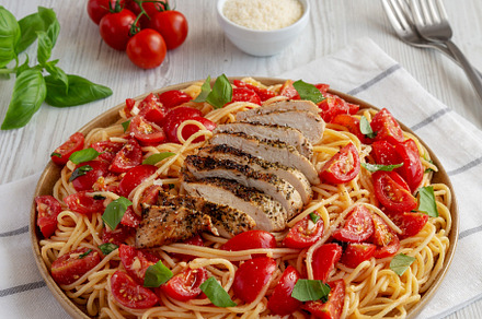 Homemade Bruschetta Chicken Pasta on a Plate, side view., a Food & Drink Photo by LiudmylaChuhunova