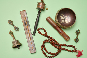 Tibetan singing copper bowl with a wooden clapper on a green bac, a Health & Medical Photo by ndanko