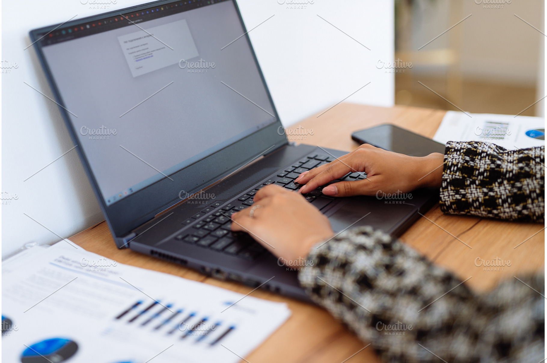 Person working on a laptop at a desk, a School & Education Photo by undrey