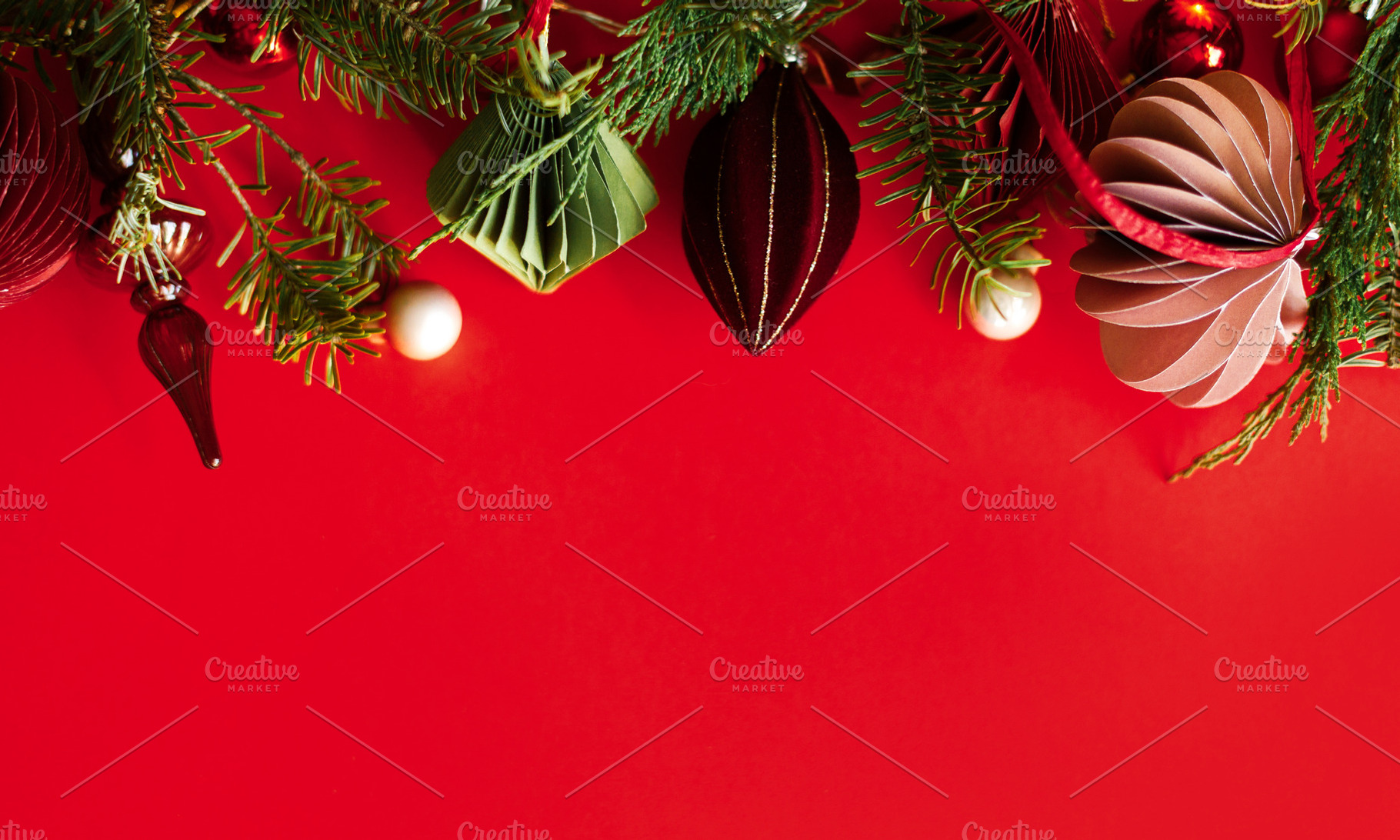 Christmas background with paper ornaments, glass finial, red bau, a Photo by Sonjachni