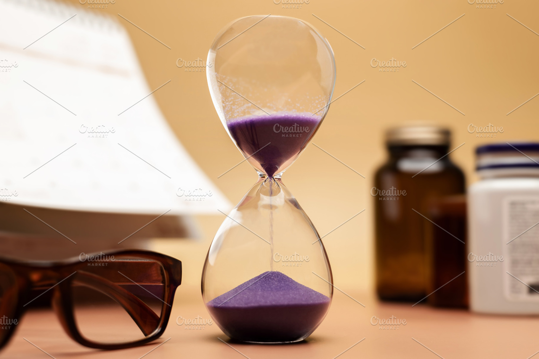 Hourglass with medicine bottle, reading glasses and calendar,agi, a Photo by salmon.black