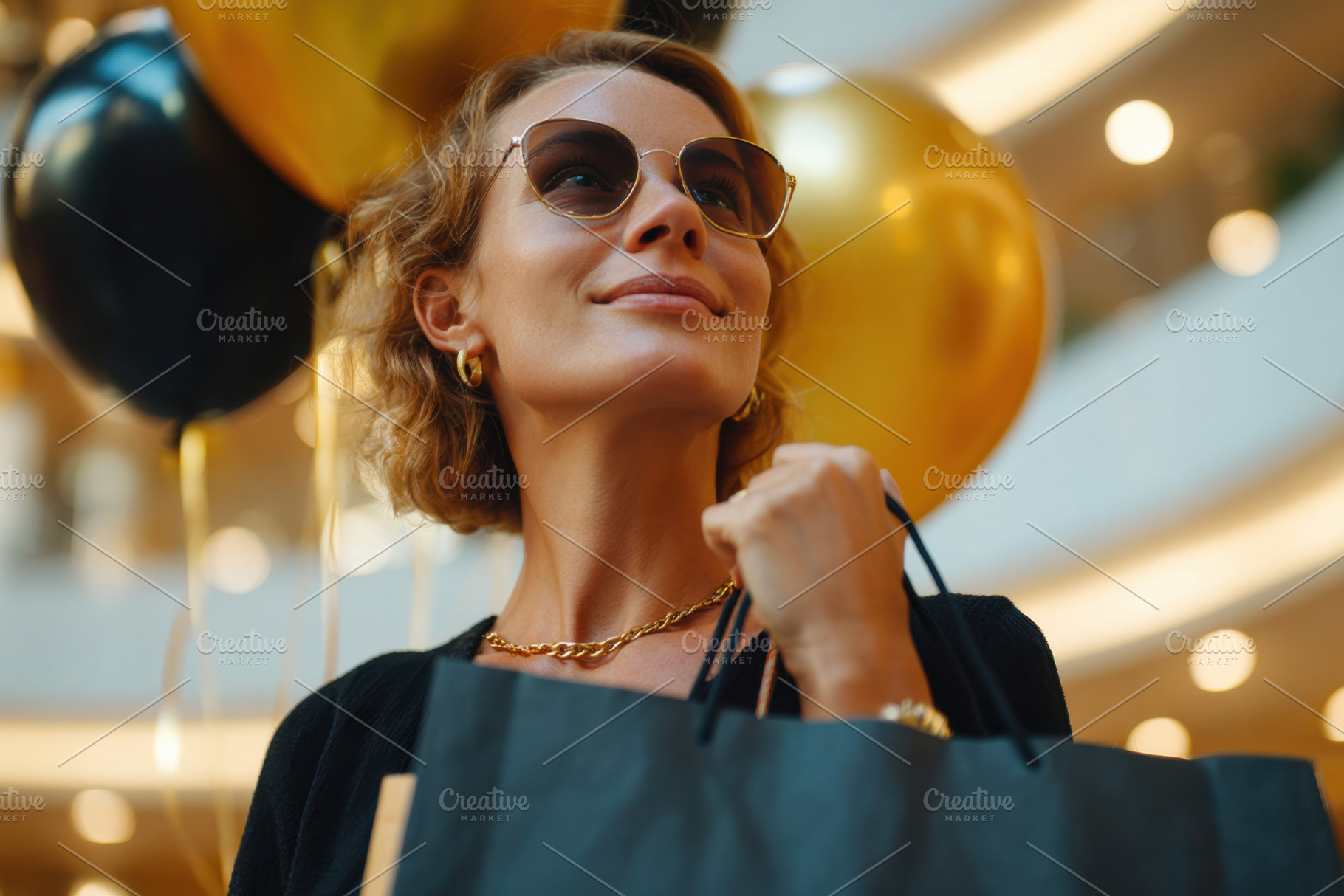 Beautiful woman holding shopping bag after shopping, a Holiday Photo by AlyaAnd