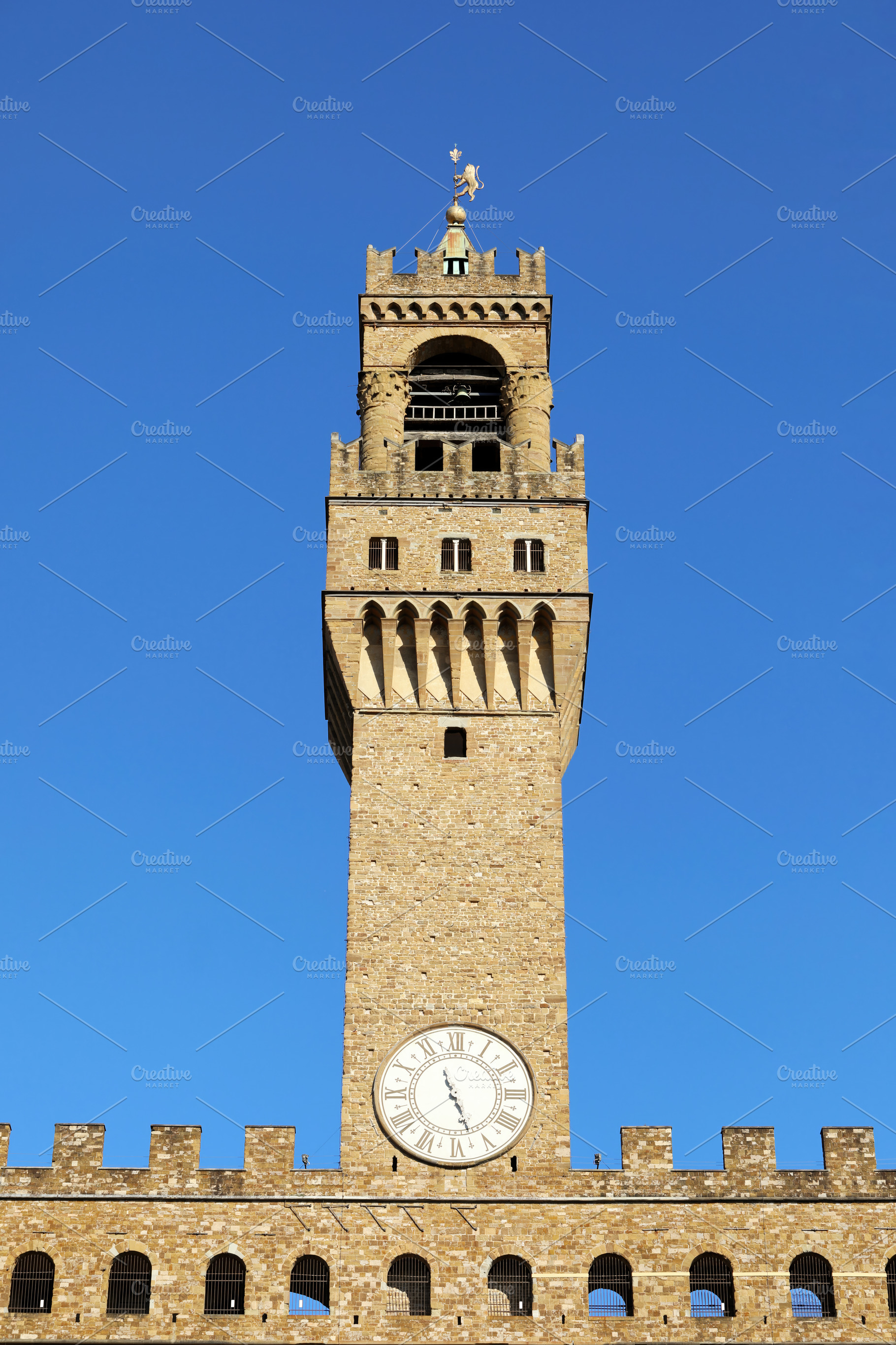 Palazzo Vecchio Tower rising majestically over Florence on a clear day, an Architecture Photo by Antonio Gravante Market