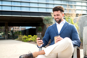Businessman using smartphone during coffee break, a Business Photo by etorres69