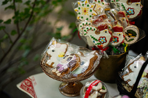 Colorful decorated cookies displayed in a glass bowl on outdoor table, a Photo by AS photostudio