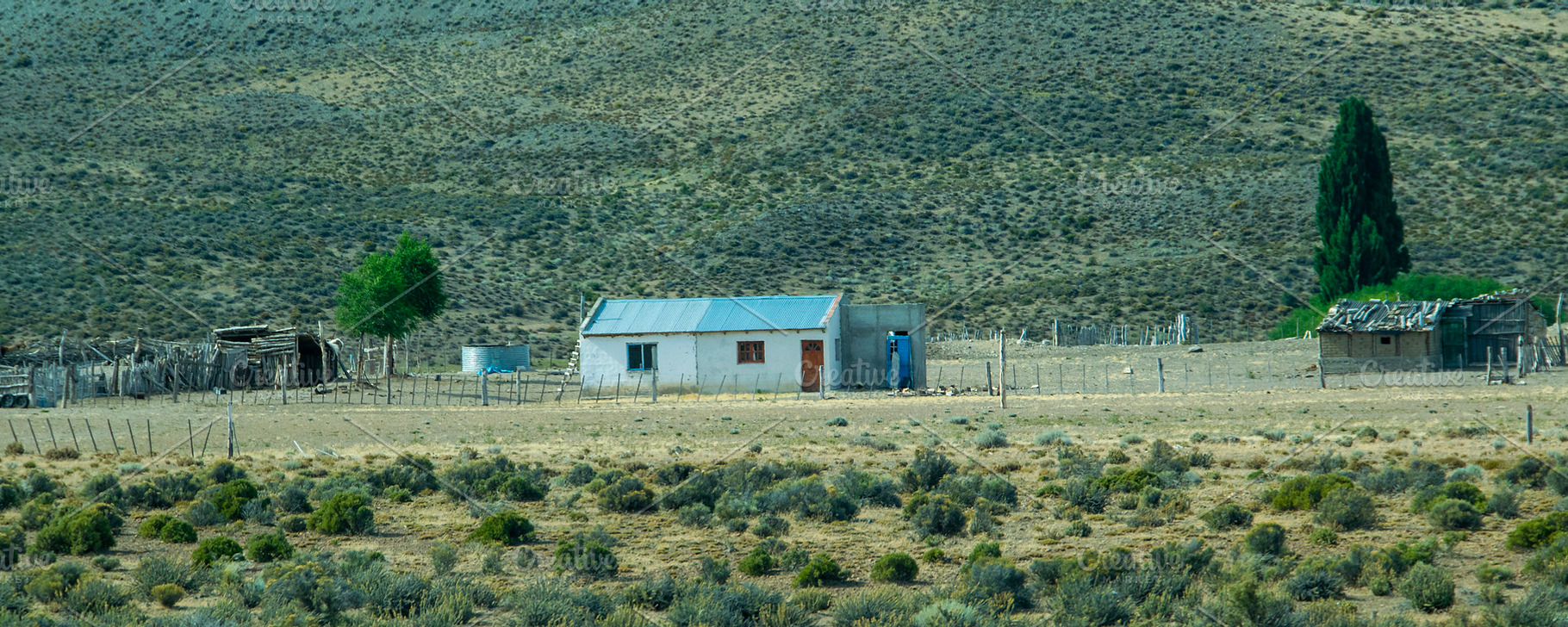 Rustic countryside house surrounded by the patagonian steppe lan, a Nature Photo by DanFLCreativo
