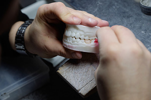 Close-up of a specialist performing accurate grinding on a high-tech dental moc, a Health & Medical Photo by Rohan Photography