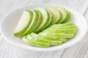 Ripe avocado sliced in white bowl, a Food & Drink Photo by Alexander Prokopenko