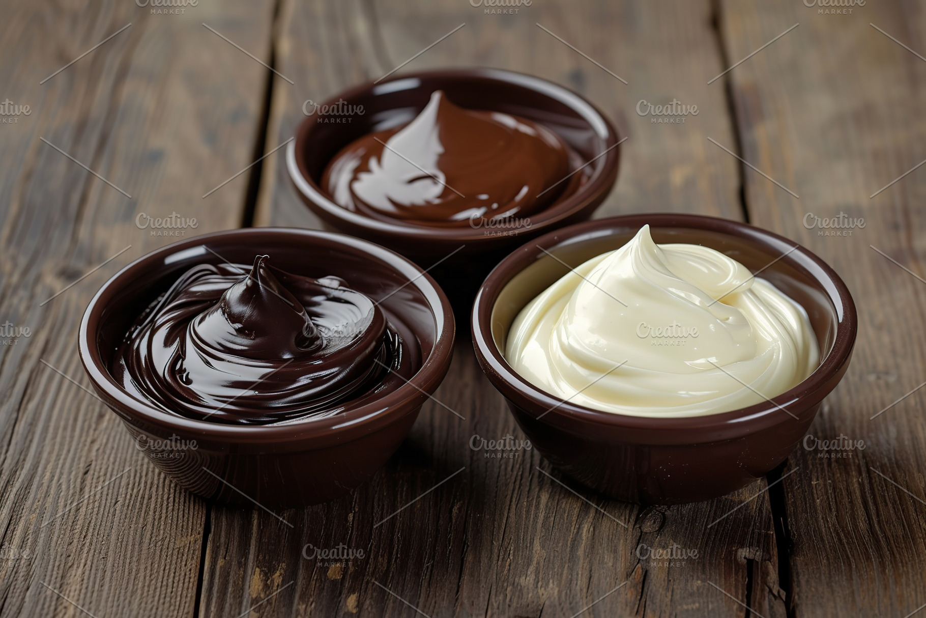 Sweet black, white and milk melted chocolate in bowls on wooden table, a Food & Drink Photo by AlyaAnd