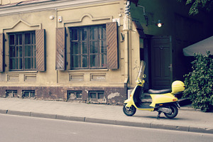 Yellow scooter on the street, a Transportation Photo by BOOCYS