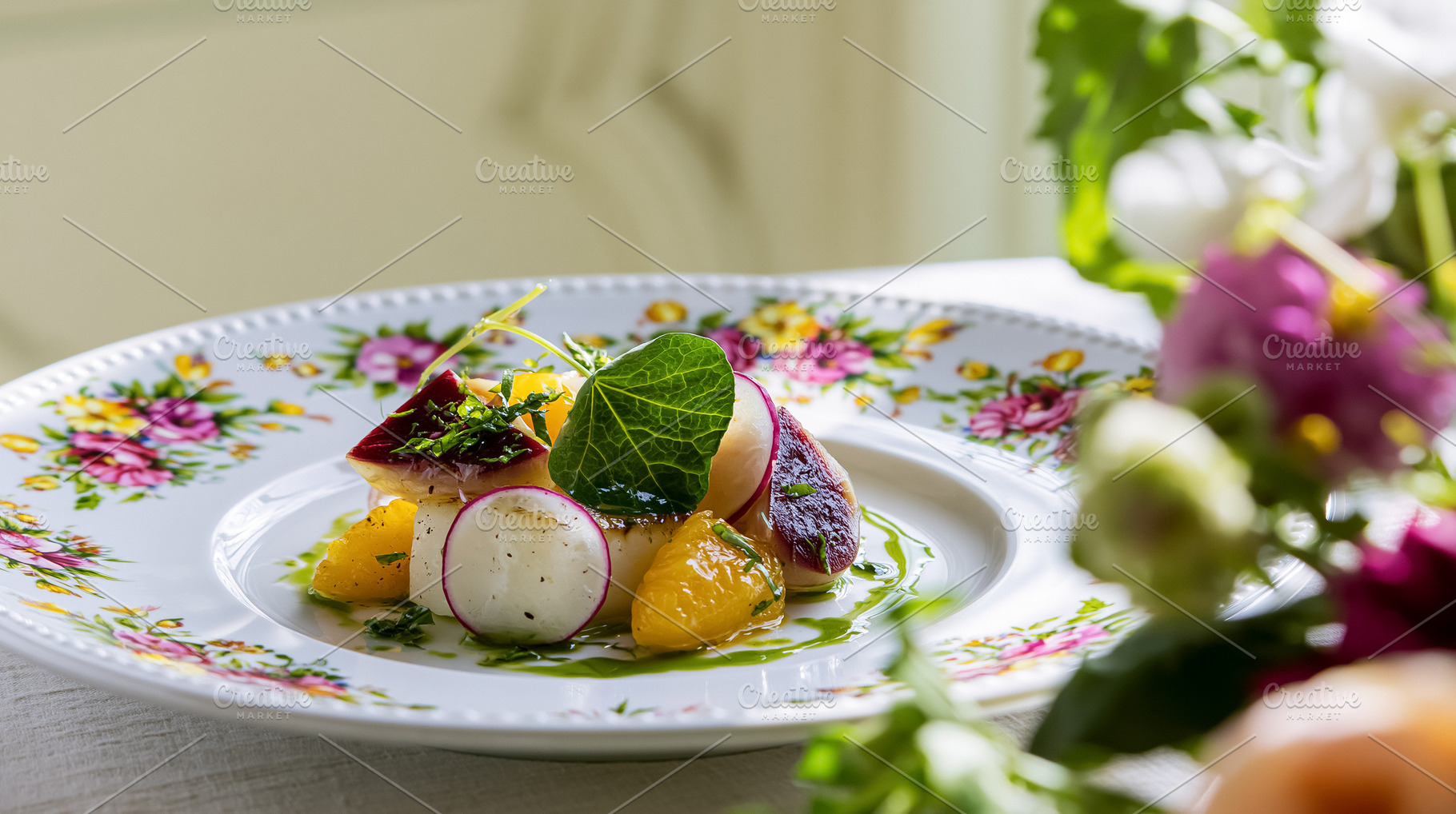 Scallops and radish appetizer with citrus segments and fresh herbs on a fine di, a Photo by Studio ANNA