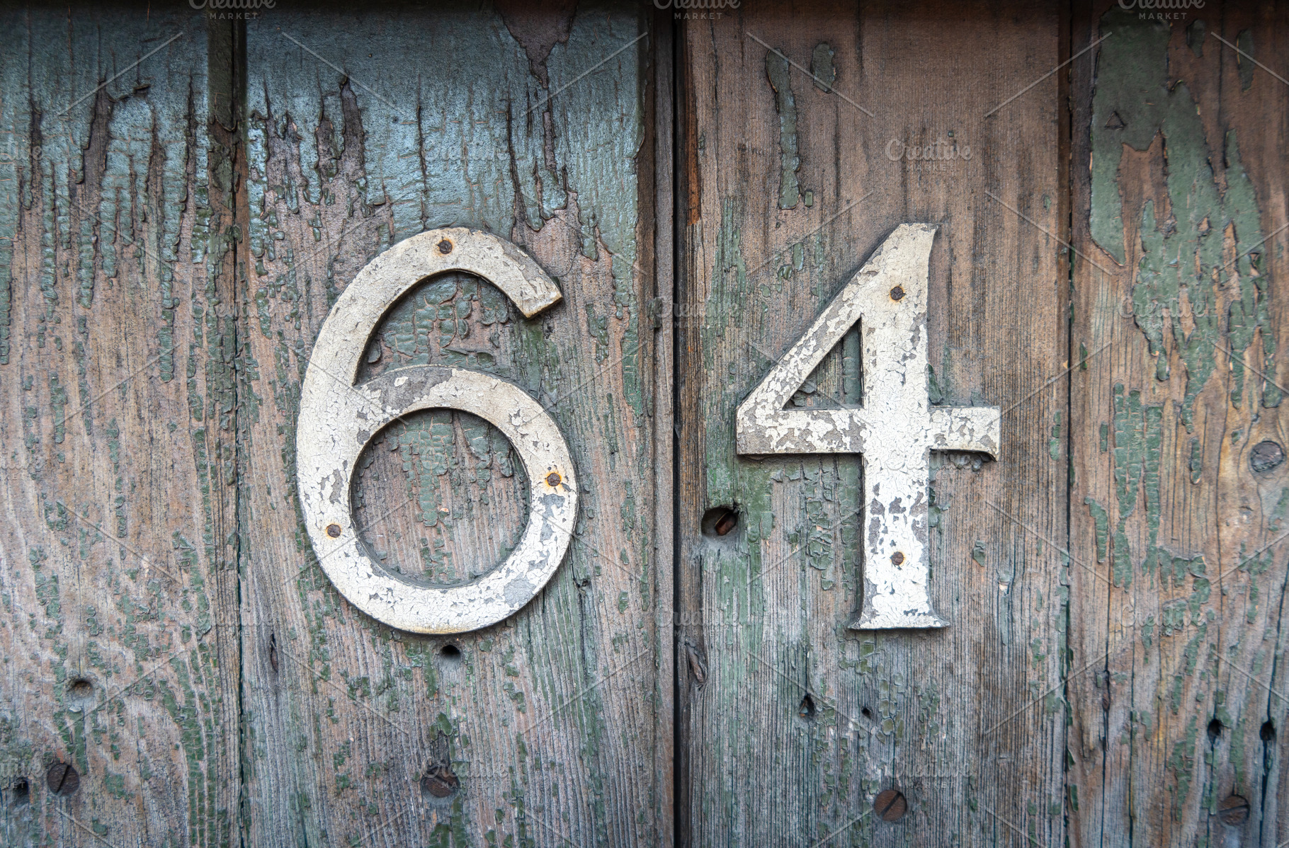 Weathered house number 64 on an old wooden surface, an Architecture Photo by GoodGoods