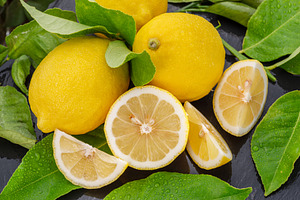 Ripe lemon fruits with slices, a Food & Drink Photo by Volff