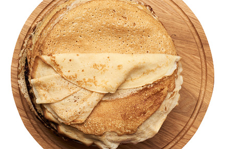 Fried round pancakes on a wooden board, top view, a Food & Drink Photo by ndanko