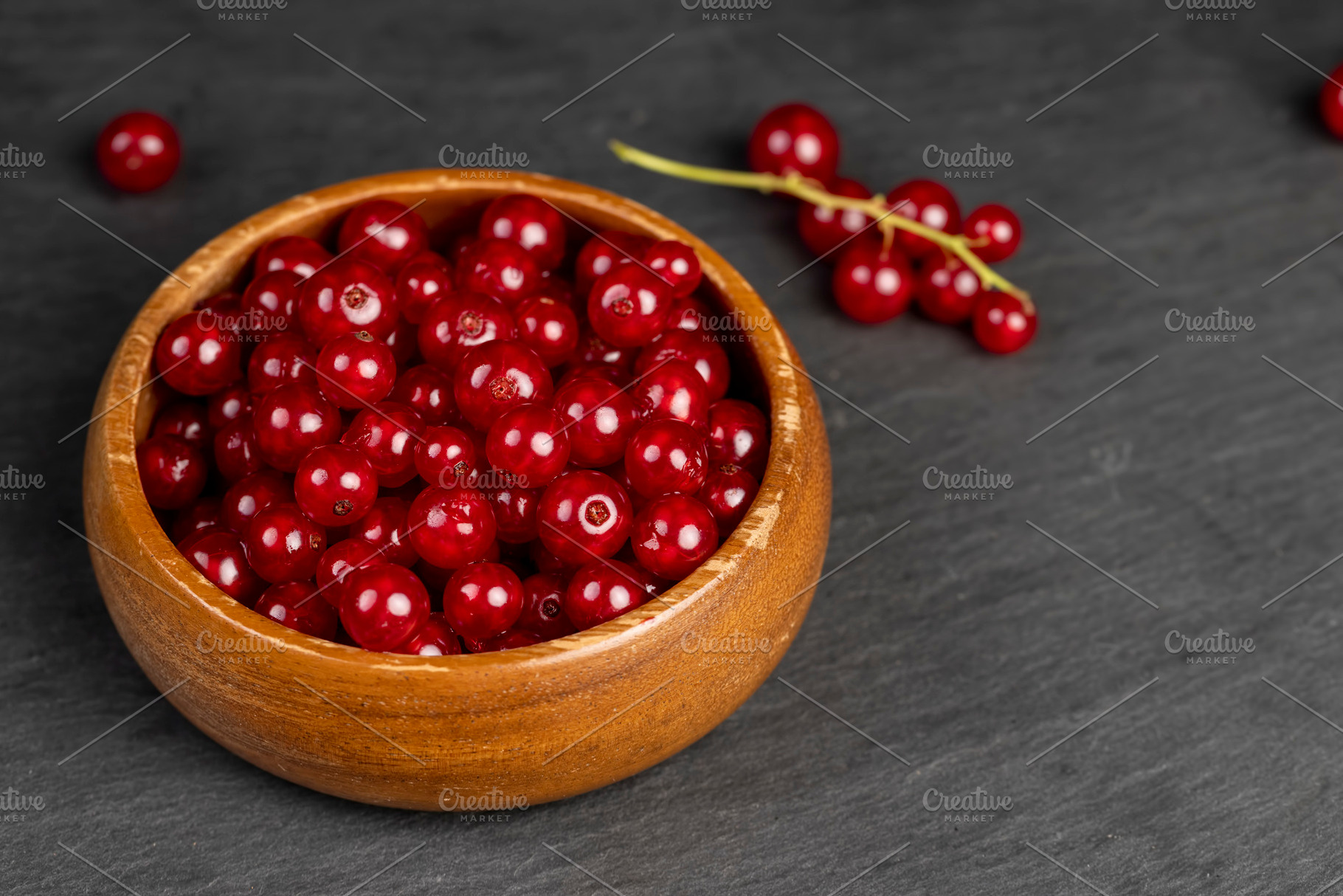 ripe red currant berries poured in a wooden bowl, harvest small red currant ber, a Photo by rsoollAI