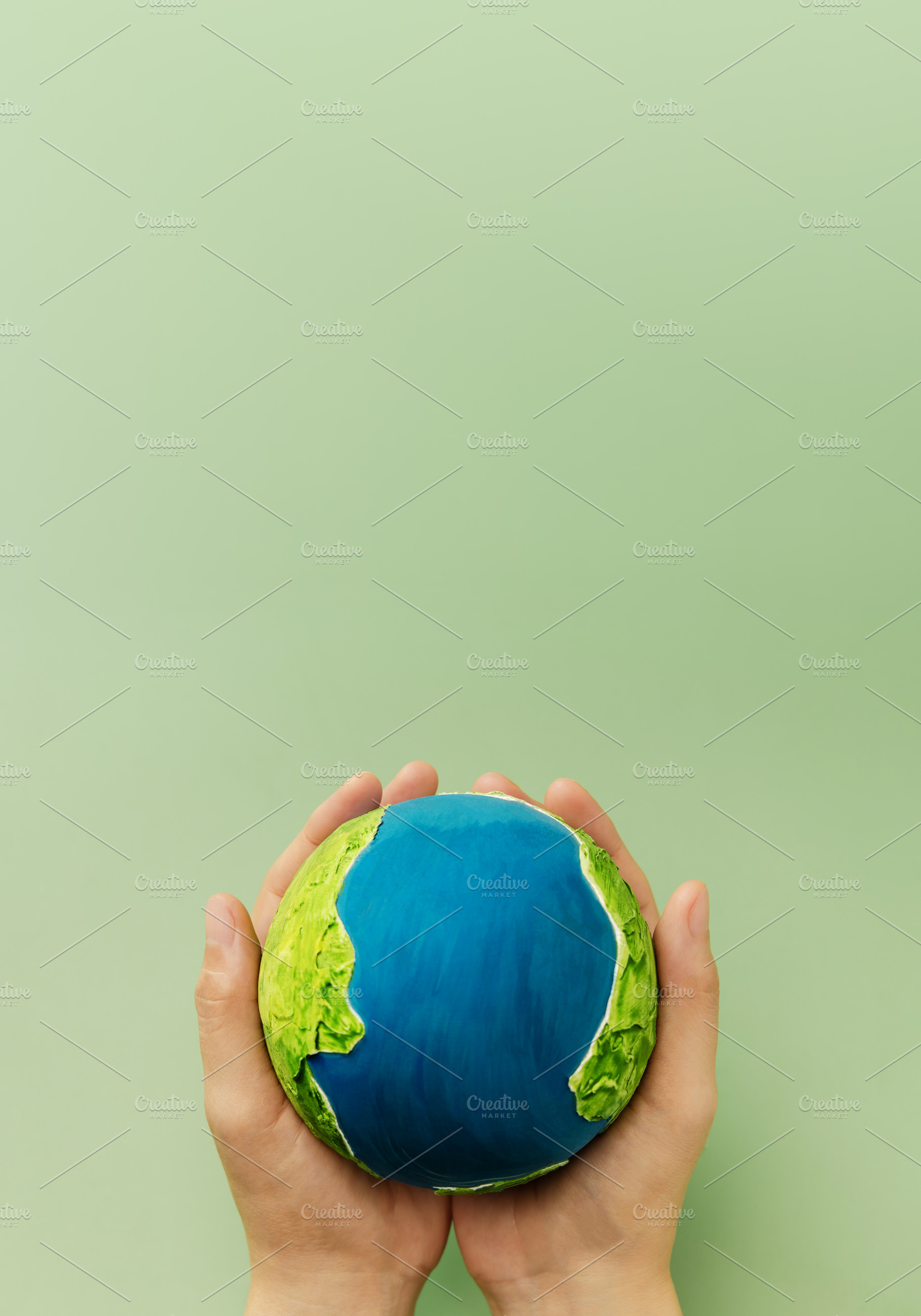 Earth in hands symbolizing sustainability, global environmental, a Photo by salmon.black