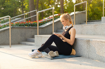 Sport and Fitness Young Adult Caucasian Woman Sitting Exercise Mat Concrete Flo, a Person Photo by andreonegin market
