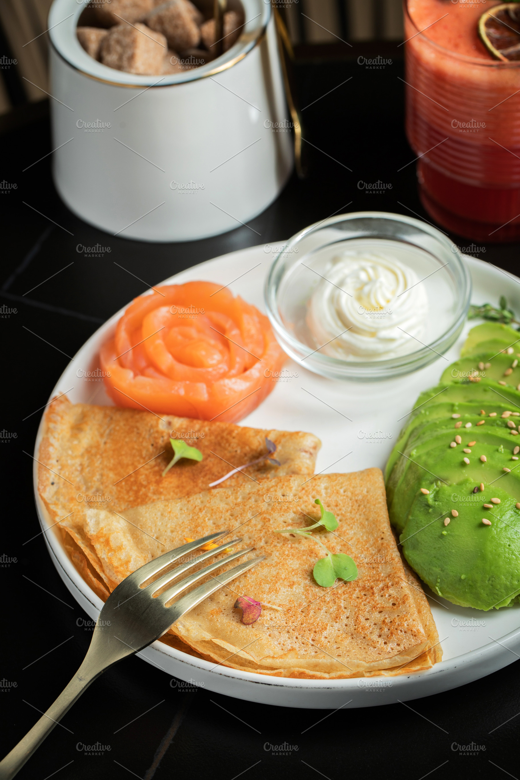 Roasted thin pancakes with smoked salmon and sauce, a Food & Drink Photo by Budarinphoto