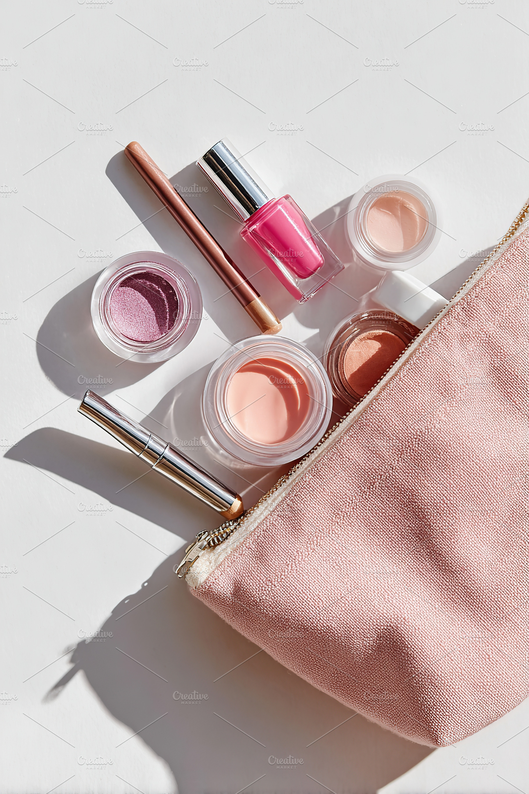 Beauty products arranged on a clean surface near a pink cosmetics bag with vibr, a Beauty & Fashion Photo by AlyaAnd