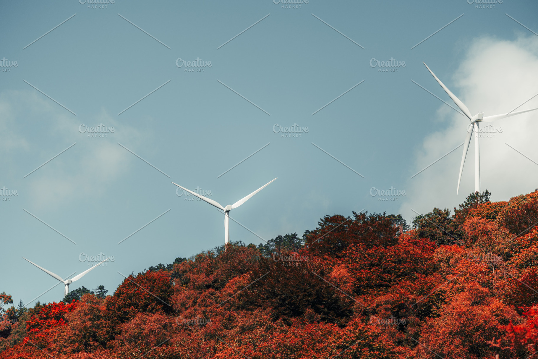 Wind turbines in autumn forest, an Industrial Photo by SkyNext