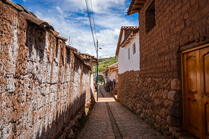 Traditional cobbled streets in Chinchero, Peru, with white adobe, an Architecture Photo by GoodGoods