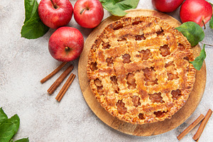 Delicious homemade apple pie decorated with fresh apples and cin, a Food & Drink Photo by Olena Rudo