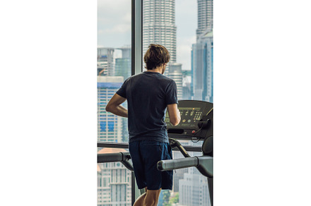 Man running in a gym on a treadmill, a Sports & Recreation Photo by Elizaveta Galitskaya