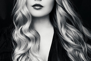 Young woman with long wavy blonde hair looking up, concept of in, a Person Photo by Studio ANNA