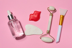 Bottle with transparent serum, red decorative lips, white gua sh, a Beauty & Fashion Photo by ndanko