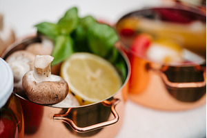 Fresh ingredients in copper pots, a Food & Drink Photo by HalfPoint