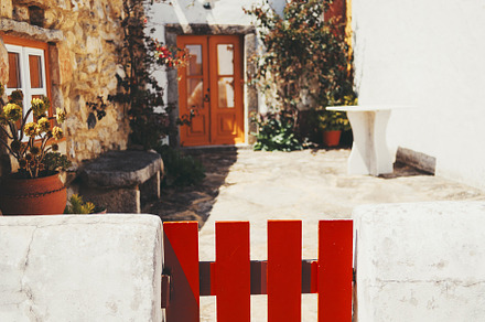 Red gate and white stucco wall, an Architecture Photo by SkyNext