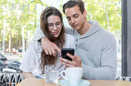 Best friends at coffee shop looking at smart phone, a Person Photo by RF Images
