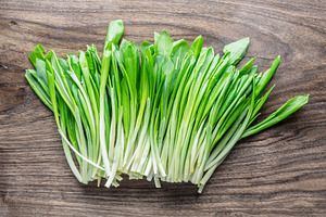 Young fresh wild garlic on the wooden table., a Food & Drink Photo by Volff