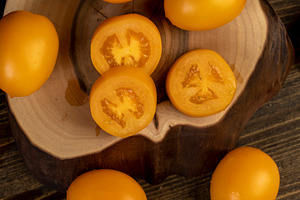 whole clean washed tomatoes are sliced for cooking, a Photo by rsoollAI