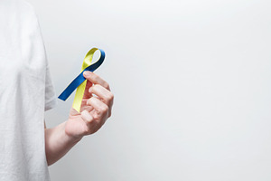 Symbolizing World Down Syndrome Day. A person wearing a white t-shirt with a ye, a Photo by matucha