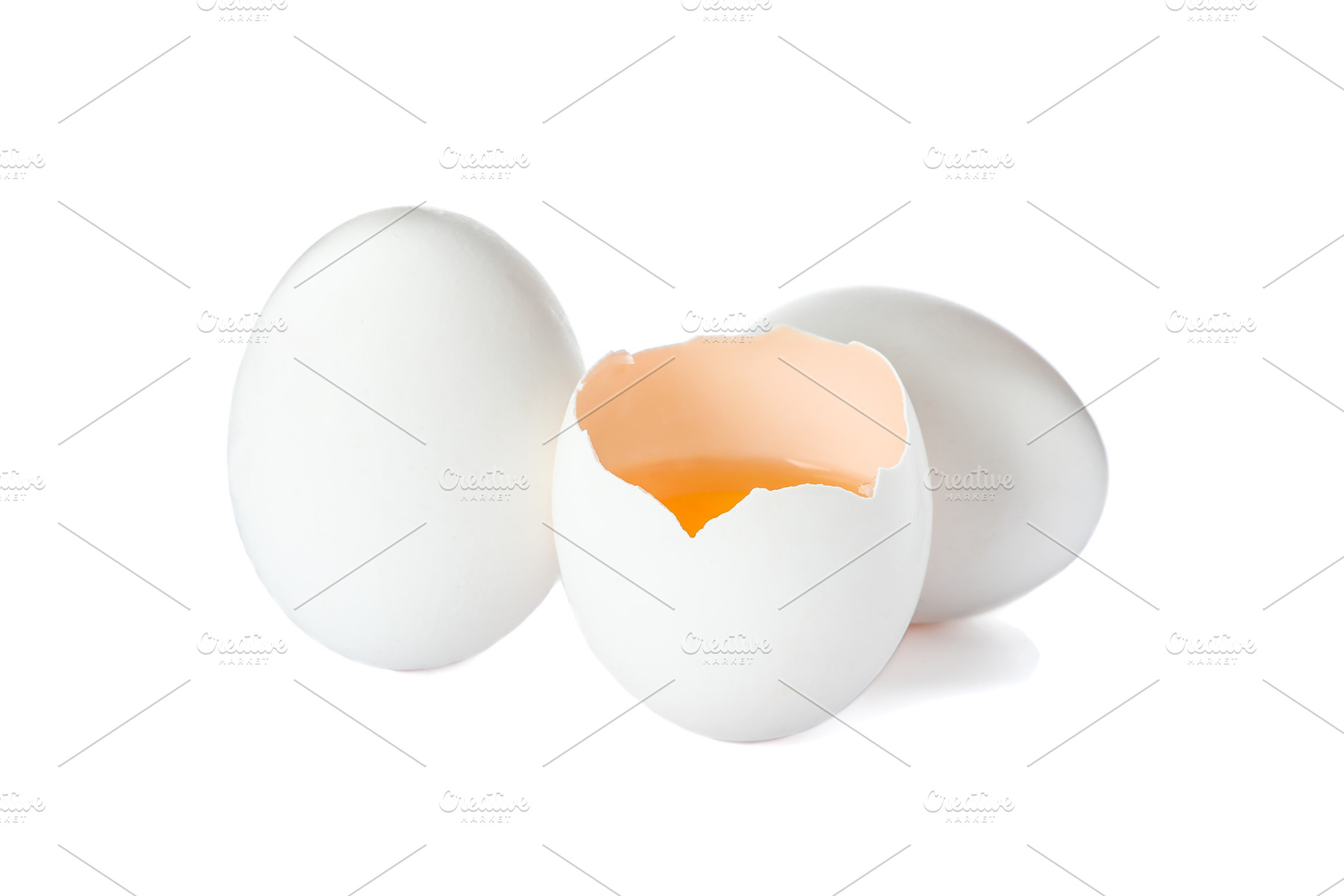 Chicken eggs and half yolk isolated on white background, a Food & Drink Photo by AtlasStudio